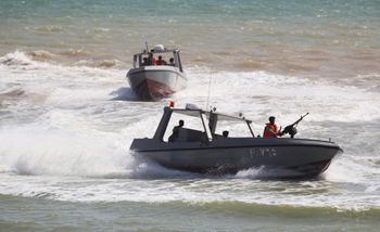 Yemen Coast Guard sailors take part in a military ceremony in Mukalla, Yemen