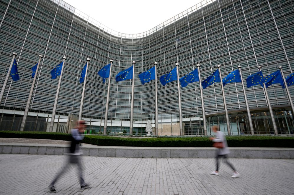(AP Photo/Virginia Mayo, File) FILE - European Union flags flap in the wind as pedestrians walk by EU headquarters in Brussels, Sept. 20, 2023