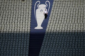 A security official walks past a Champions League trophy logo during an Inter Milan training session at the Ataturk Olympic Stadium in Istanbul, Turkey, Friday, June 9, 2023.