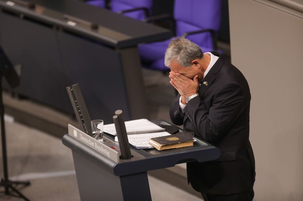 Mickey Levy, speaker of Israel's parliament (the Knesset), recites the Mourner's Kaddish from a Holocaust-era prayer book during a speech to the German Bundestag on January 27, 2022.