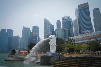 FILE - Merlion statue with a background of the business district in Singapore.