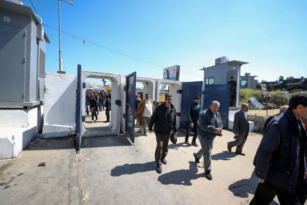 Palestinians make their way through an Israeli border checkpoint, near the West Bank city of Ramallah.