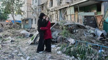 People react as they look at the site of a Russian missile strike that hit a residential building in Kyiv, Ukraine, Tuesday, June 2, 2026. 