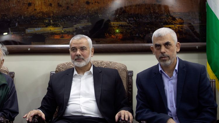 FILE - Hamas's military commander Yahye Sinwar (right) and political chief Ismail Haniyeh