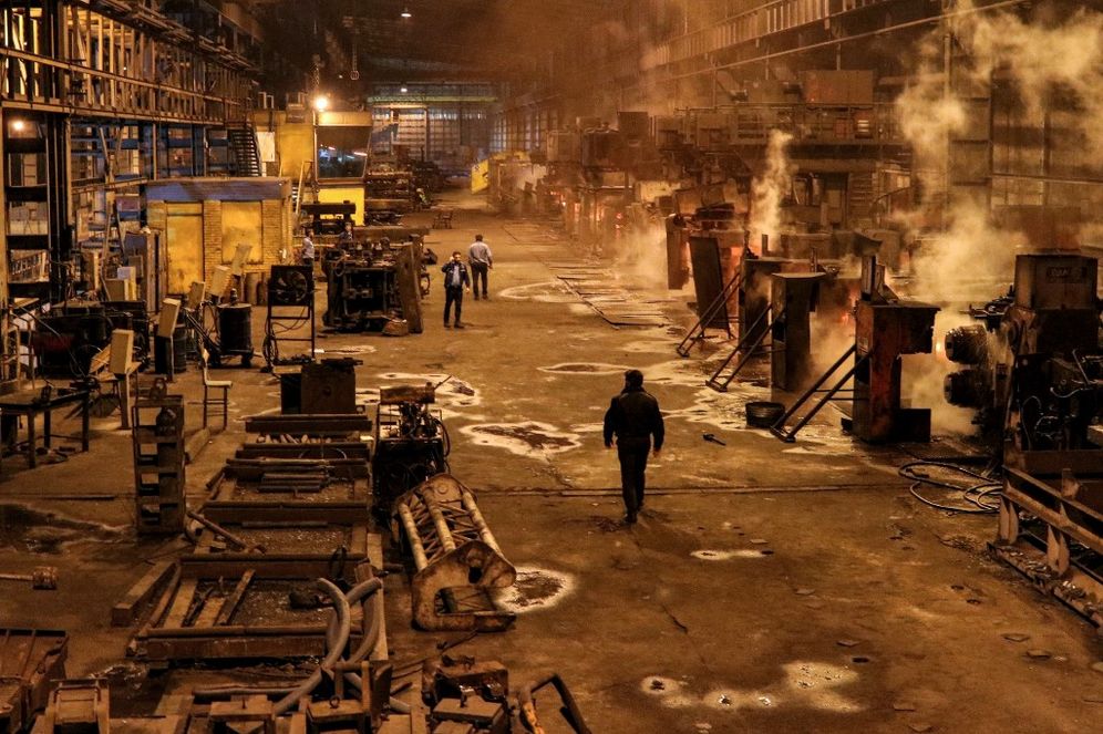 Reza SOLEYMANI ROUZBEHANI / ISNA / AFP Steel workers walk at the Iran National Steel Industrial Group facility in Ahvaz in Iran's southwestern Khuzestan province.