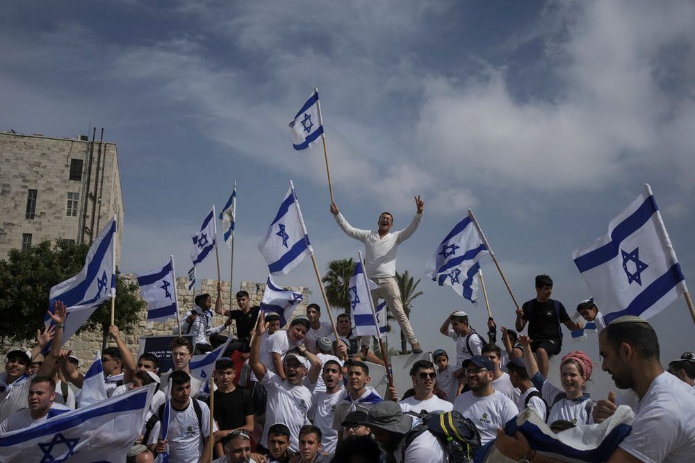 Israelis wave national flags during a march marking Jerusalem Day, just outside Jerusalem's Old City.