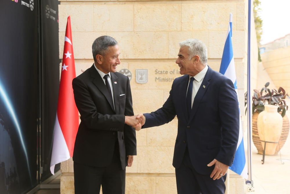 Israel’s Foreign Minister Yair Lapid shakes hands with Singapore's Foreign Minister Vivian Balakrishnan in Jerusalem on March 21, 2022.