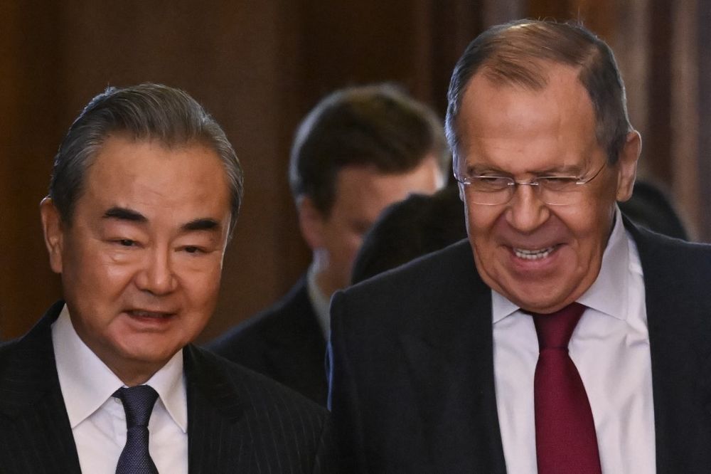 Russian Foreign Minister Sergei Lavrov and China's Director of the Office of the Central Foreign Affairs Commission Wang Yi enter a hall during a meeting in Moscow, Russia.
