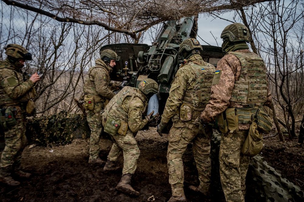 Ukrainian servicemen load a 152 mm shell into a Msta-B howitzer to fire toward Russian positions, near the frontline town of Bakhmut, Ukraine.