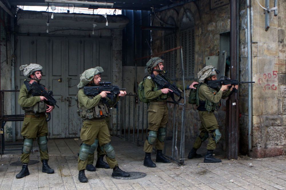Israeli soldiers stand guard in the West Bank city of Hebron.