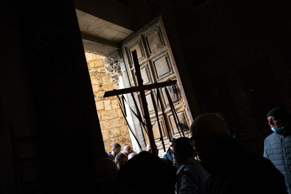 Catholic worshippers hold crosses as they take part in a Good Friday procession in Jerusalem's Old City on April 02, 2021.