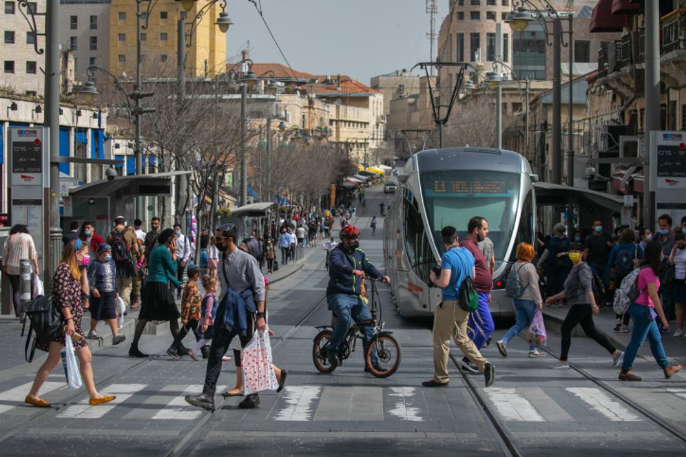 Des gens marchent à Jérusalem le 21 mars 2021.
