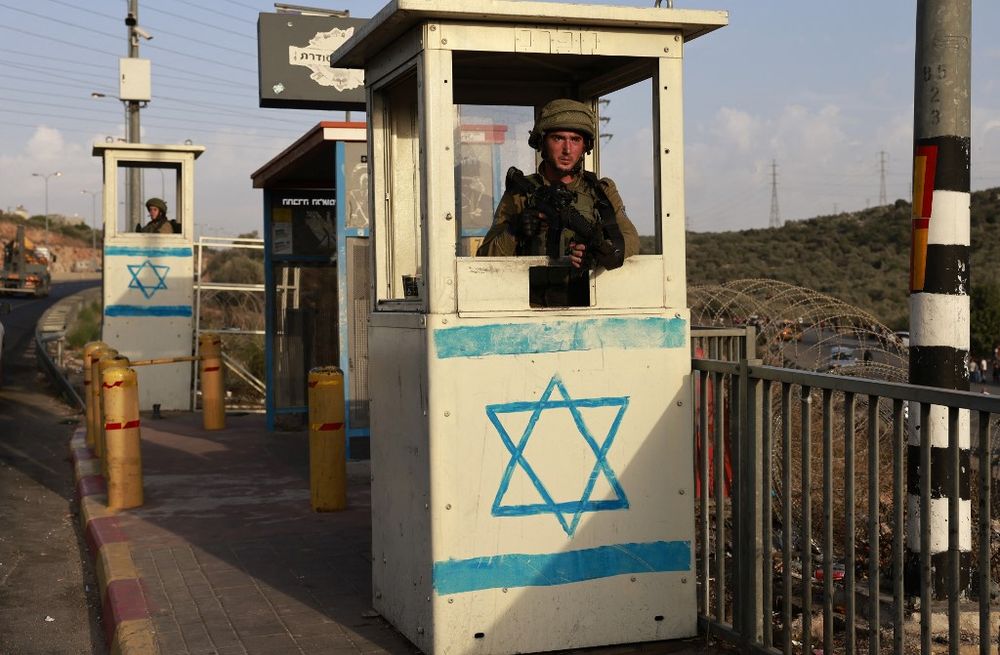 An Israeli soldier on guard at a bus station near the Jewish settlement of Ariel in the West Bank.