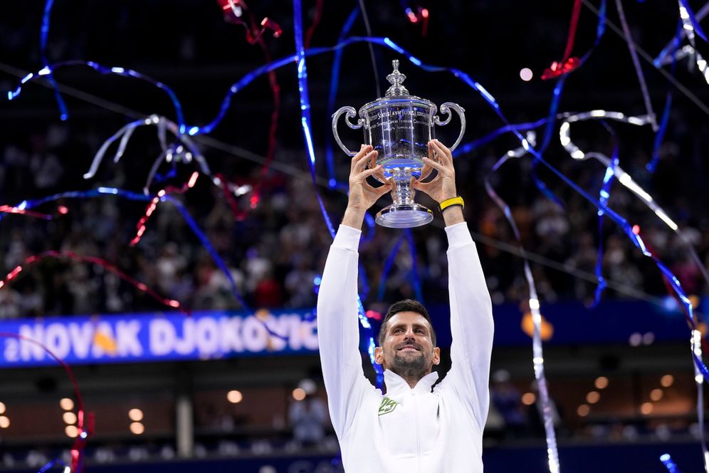 Novak Djokovic, of Serbia, holds up the championship trophy after defeating Daniil Medvedev, of Russia, in the men's singles final of the U.S. Open tennis championships.