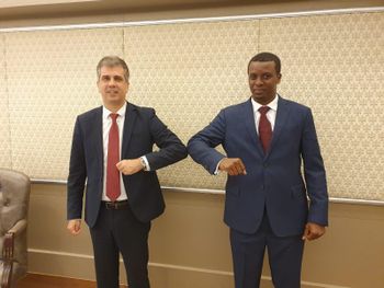 Israel's Intelligence Minister Eli Cohen (left) and Chad's cabinet chairman Abdelkarim Déby  share a socially distanced greeting at a meeting in Jerusalem on September 8, 2020.