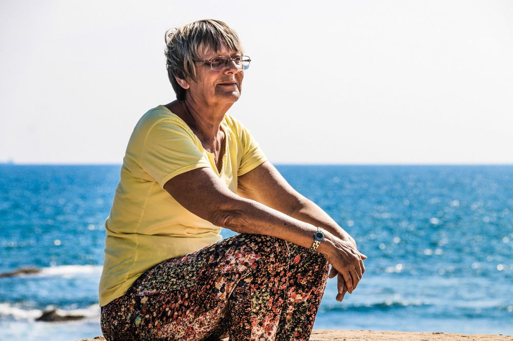 Woman sitting on the seashore