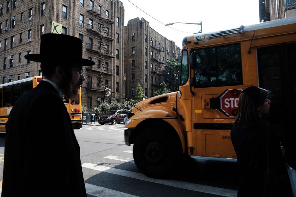 A yeshiva school bus drives through in the Brooklyn borough of New York City, United States.