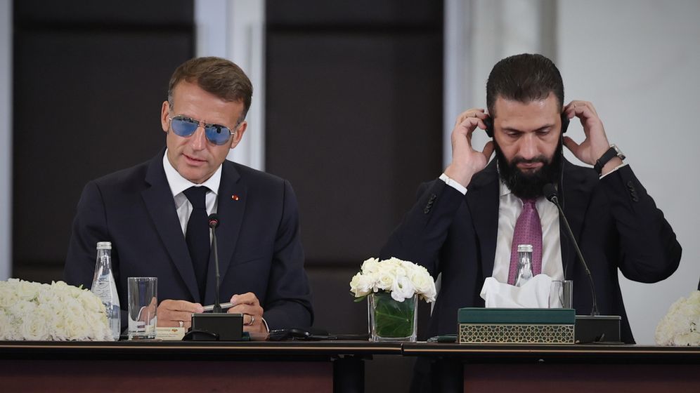 AP Photo/Ghaith Alsayed French President Emmanuel Macron, left, speaks as Syrian President Ahmad al-Sharaa adjusts his headset during an event at the Economic Forum for Reconstruction in Damascus, Syria, Tuesday, July 7, 2026.