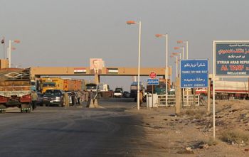 Cars wait at a checkpoint at the Syrian-Iraqi border point of Al-Tanf, northeast of Damascus, Syria, on October 2, 2004.