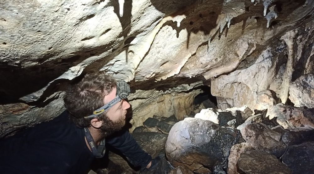 Israeli archeologist exploring a crevice in the Twins Cave in Israel, near Bet Shemesh.
