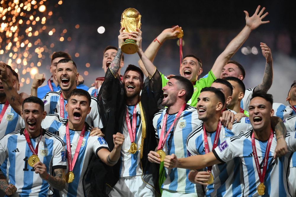 Argentina's forward Lionel Messi lifts the World Cup trophy during the Qatar 2022 World Cup trophy ceremony after the final between Argentina and France in Lusail, north of Doha on December 18, 2022.
