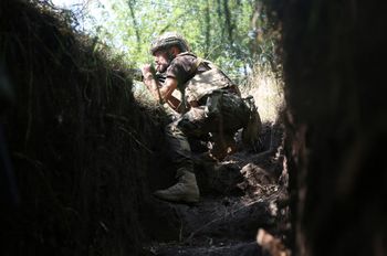 A Ukrainian marine keeps watch from a position on the frontline with Russia-backed separatists close to the separatist stronghold Donetsk, eastern Ukraine, September 13, 2021.