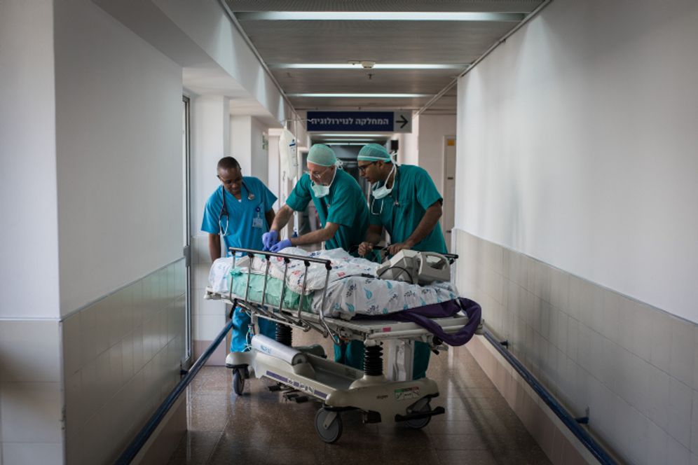 Doctors and nurses take a child patient to the emergency room for recovery after undergoing open-heart surgery at Wolfson Medical Center in Holon, Israel, on August 13, 2018.