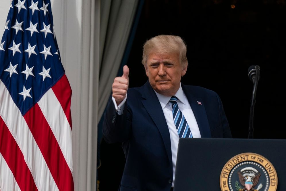US President Donald Trump gives a thumbs-up as he departs after speaking from the Blue Room Balcony of the White House to a crowd of supporters in Washington DC, on October 10, 2020.