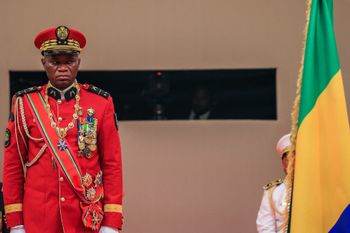 Gabon's new strongman General Brice Oligui Nguema (R) salutes as he is inaugurated as Gabon's interim President, in Libreville.