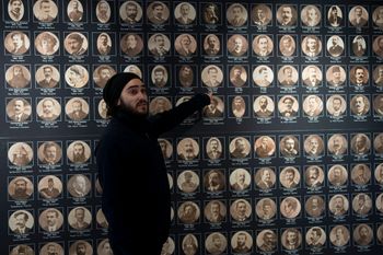 Tour guide Arek Kahkedjian gestures to a display on the Armenian genocide in the Armenian Museum in the Old City of Jerusalem, January 11, 2023.