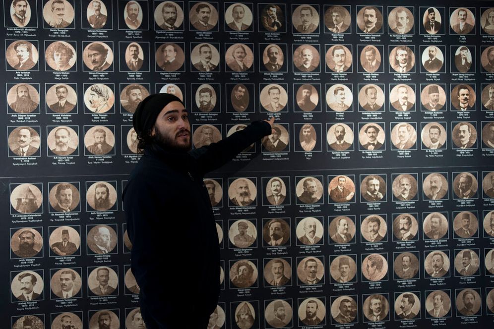 Tour guide Arek Kahkedjian gestures to a display on the Armenian genocide in the Armenian Museum in the Old City of Jerusalem, January 11, 2023.