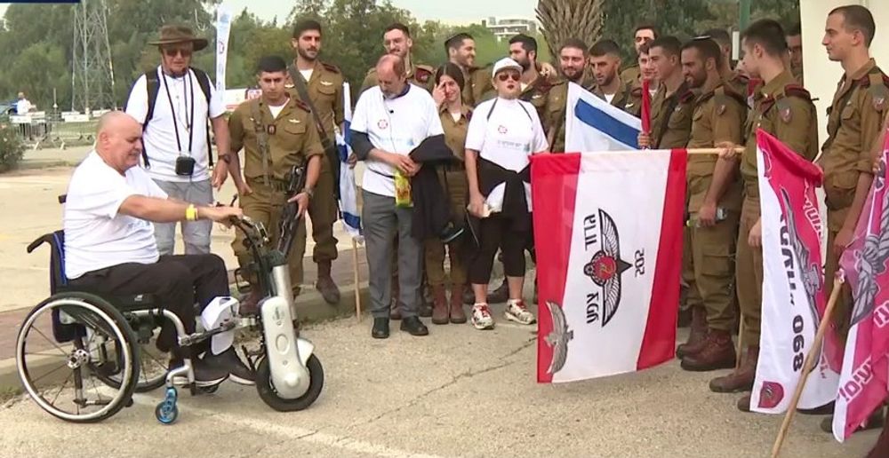 A disabled Israeli military veteran (L) addresses soldiers during a march in support of disabled veterans, in Tel Aviv, Israel.