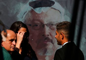 Journalists talk in front of a picture of slain Saudi journalist Jamal Khashoggi during a ceremony, near the Saudi Arabia consulate in Istanbul, Turkey, on October 2, 2019.