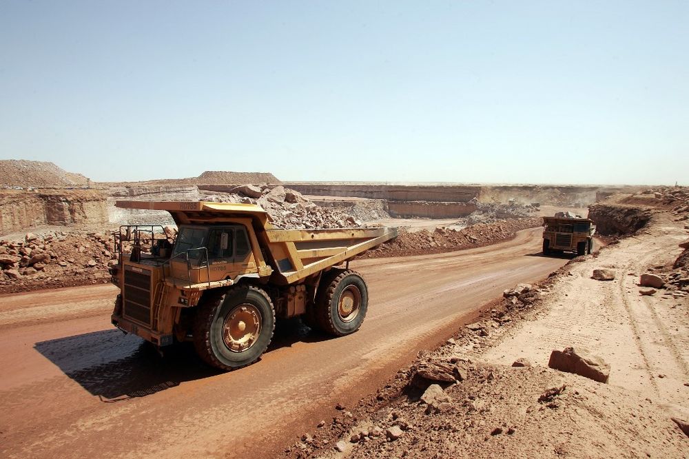 Trucks carry rocks containing uranium 23 February 2005 at the Arlit opencast mine in the Air desert, Niger, one of the world's most impoverished regions.