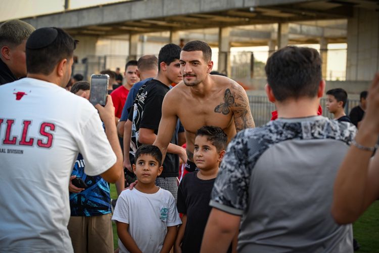 Supporters of Hapoel Be'er Sheva and players celebrating the opening of the football season in the southern Israeli city of Be'er Sheva, August 13, 2025. 