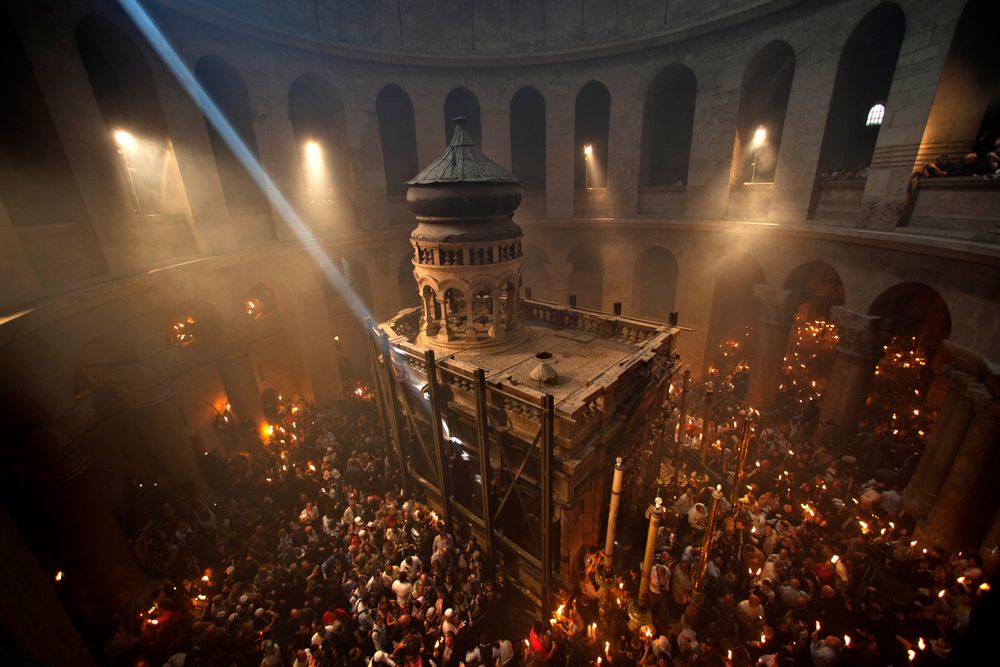 Christian pilgrims hold candles at the Church of the Holy Sepulchre, traditionally believed to be the burial site of Jesus Christ, during the ceremony of the Holy Fire in Jerusalem's Old City, Saturday, April 14, 2012.