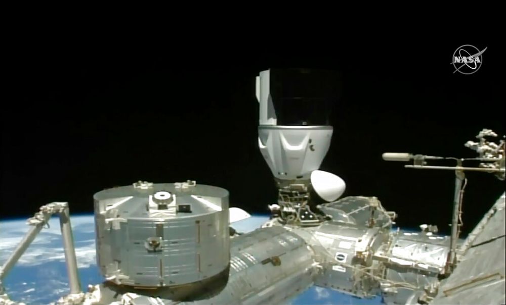 A SpaceX capsule carrying four astronauts docks at the International Space Station.
