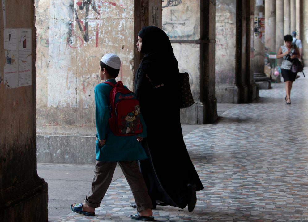 A Muslim woman walks in downtown Rome Wednesday, Aug. 3, 2011. An Italian parliamentary commission has approved a draft law banning women from wearing veils that cover their faces in public. The draft passed by the constitutional affairs commission on Tuesday would prohibit women from wearing a burqa, naqib or any other garb that covers the face in such circumstances. 
