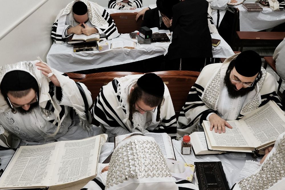 Members of an ultra-Orthodox Jewish community study the Torah in Williamsburg, Brooklyn on Yom Kippur, October 12, 2016, in New York City, the United States.