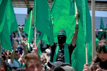 Palestinian student supporters of Hamas in Gaza wave the movement's flag during a rally at Birzeit University, near the West Bank city of Ramallah, on May 19, 2022.