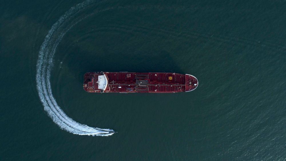 In this Sunday, July 21, 2019 photo, an aerial view shows a speedboat of Iran's Revolutionary Guard moving around the British-flagged oil tanker Stena Impero which was seized in the Strait of Hormuz by the Guard, in the Iranian port of Bandar Abbas.