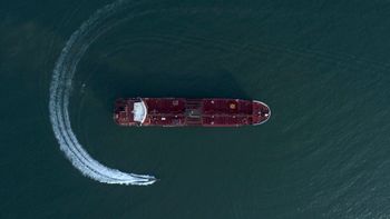 In this Sunday, July 21, 2019 photo, an aerial view shows a speedboat of Iran's Revolutionary Guard moving around the British-flagged oil tanker Stena Impero which was seized in the Strait of Hormuz by the Guard, in the Iranian port of Bandar Abbas.
