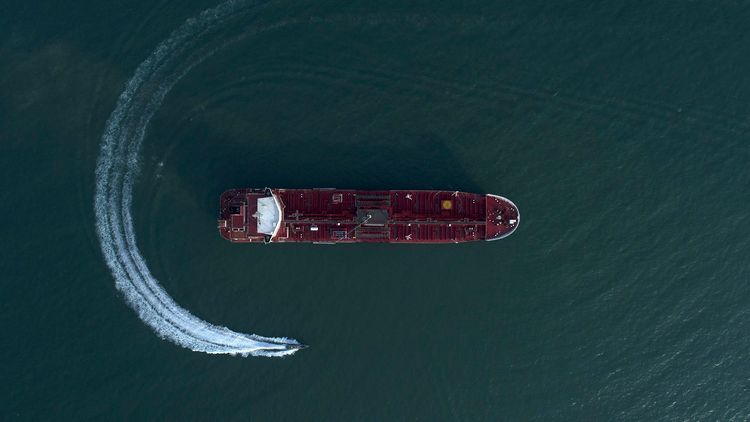 In this Sunday, July 21, 2019 photo, an aerial view shows a speedboat of Iran's Revolutionary Guard moving around the British-flagged oil tanker Stena Impero which was seized in the Strait of Hormuz by the Guard, in the Iranian port of Bandar Abbas.