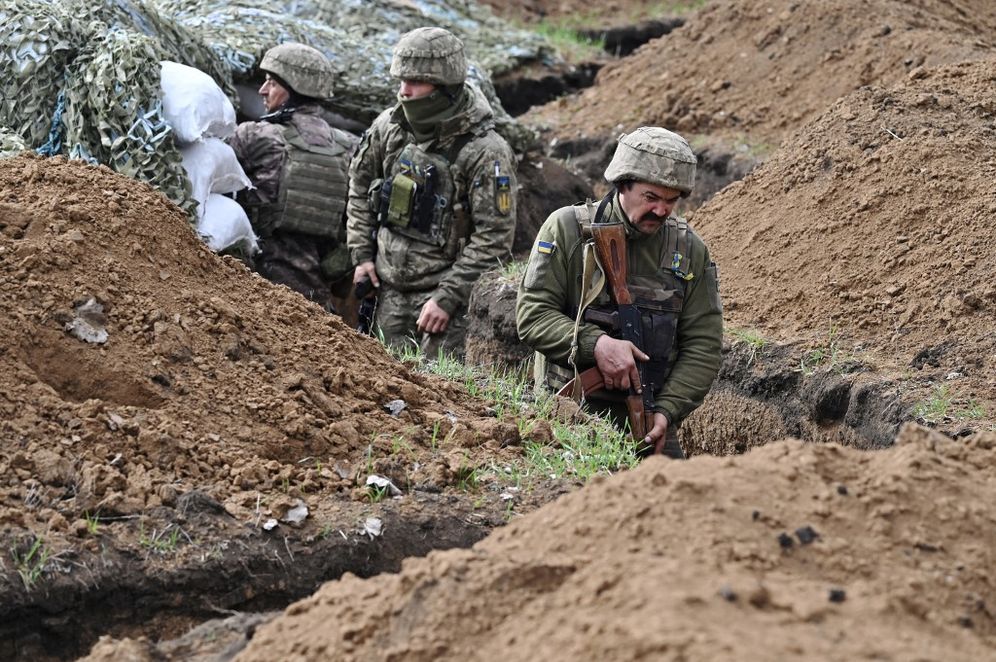 Ukrainian servicemen stand in a trench in their position near the town of Bakhmut, Donetsk region, Ukraine.