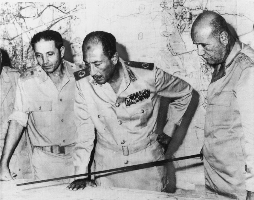Egyptian President Anwar al-Sadat is flanked by Chief of Staff Sadedin Shazli, right, and War Minister General Ahmed Ismail, right, at his Army headquarters in Cairo, on October 15, 1973.