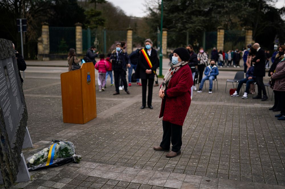 The mother of Loubna Lafquiri, who was killed during the Brussels attacks in 2016, stands next to a monument in honor of Lafquiri during an event marking the fifth anniversary of the attacks, Brussels, March 22, 2021.