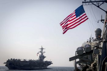 the Nimitz-class aircraft carrier USS Carl Vinson (L) and the Arleigh Burke-class guided-missile destroyer USS Wayne E. Meyer during a surface maneuvers exercise on March 22, 2017