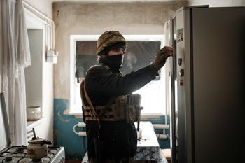 A servicemen of the Ukrainian Armed Forces Vedmak unit prepares to patrol the frontline from an abandoned house near Bakhmut, Ukraine.
