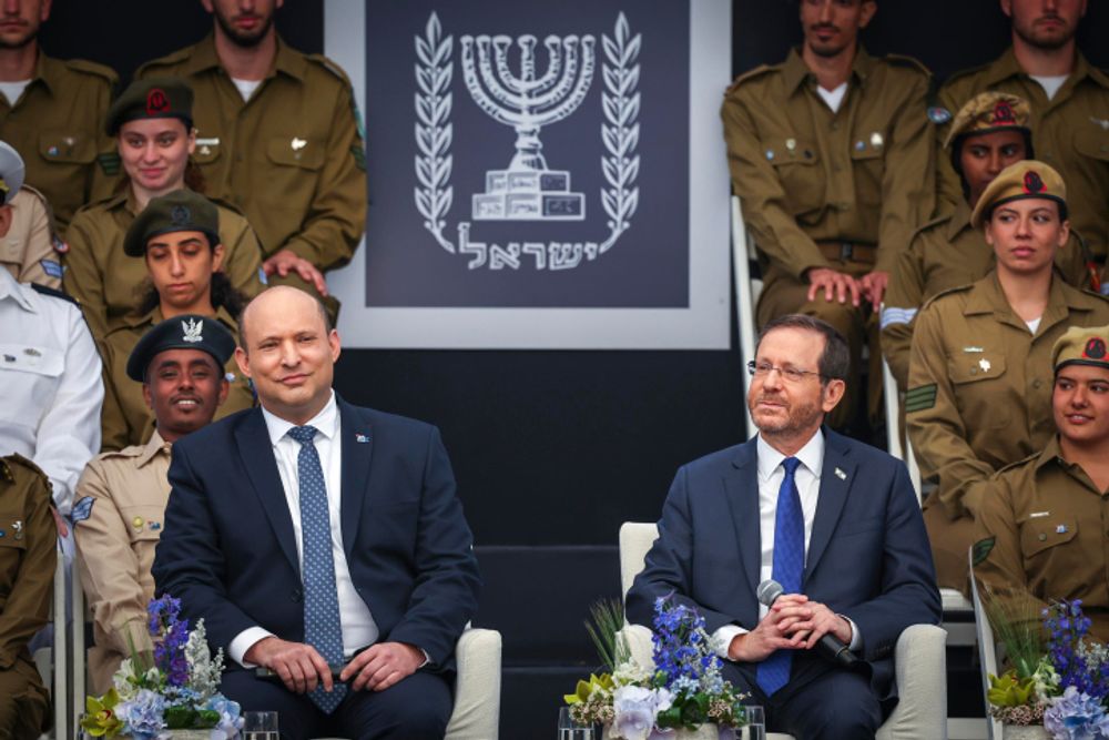 Israel's President Isaac Herzog (R) and Prime Minister Naftali Bennett look on during an event for outstanding soldiers as part of Israel's 74th Independence Day celebrations in Jerusalem on May 5, 2022.