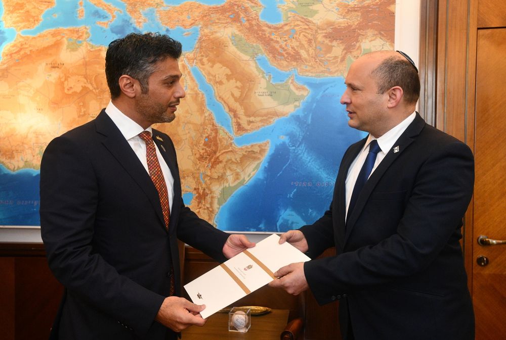 Israeli Prime Minister Naftali Bennett, right, receiving an invitation to visit the United Arab Emirates from UAE Ambassador to Israel Mohamed Al Khaja, October 19, 2021.